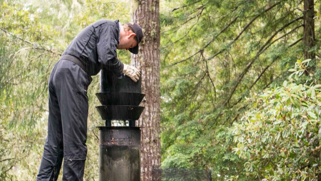 person inspecting a chimney - safeflow