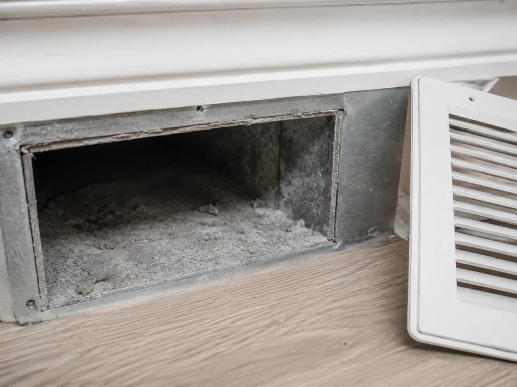 Heavy dust buildup inside a home air duct before SafeFlow cleaning in Maryland